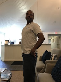 a man standing in front of a couch in a living room